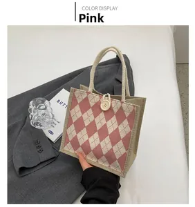 Detail of pink diamond pattern canvas tote bag with woven rope handle and button closure