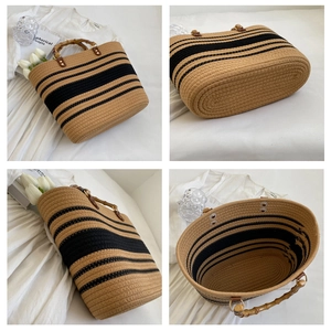 Detail view of woven straw tote bag featuring bamboo handles and striped pattern texture