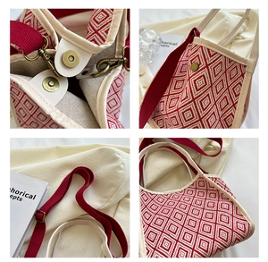 Close-up of geometric red and white woven bucket bag with brass hardware and magnetic snap