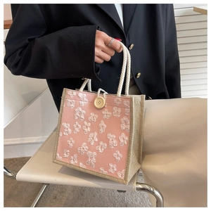Pink and straw woven handbag featuring white 3D floral texture and cream cotton rope handle
