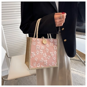 Pink linen lunch bag detail with white floral embroidery and cotton rope handles