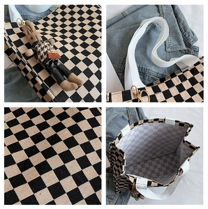Detail view of checkerboard canvas tote bag with bunny charm and interior space