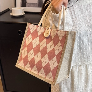 Pink and white argyle canvas tote bag with woven rope handles and large button closure
