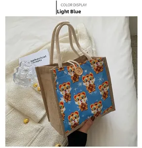 Close-up of cute tiger print linen tote bag with rope handles and wooden button closure