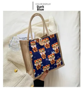 Detail of cute dark blue tiger pattern tote bag with wooden button and braided handles