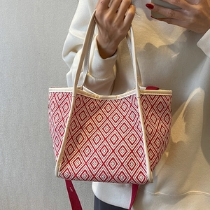 Fashionable red and white geometric knit tote bag with white leather straps and crossbody strap