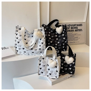 Collection of heart pattern canvas tote bags in black and white with heart plush charms