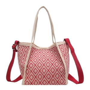 Red and white geometric woven tote bag with adjustable shoulder strap on white background