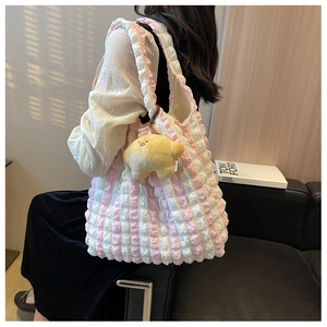 Detail of pink plaid puff tote bag with soft pleated fabric and yellow star plush charm