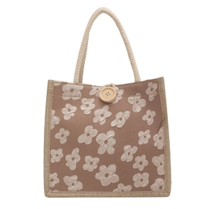 Minimalist linen lunch tote bag with floral embroidery and wooden button closure