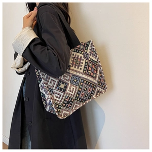 Detail of bohemian geometric woven canvas tote bag with colorful ethnic patterns