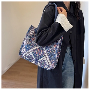 Detailed texture of ethnic geometric pattern canvas tote bag with woven shoulder strap