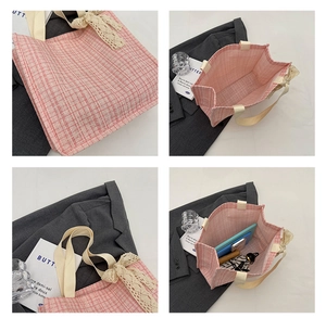 Detail view of pink tweed tote bag capacity showing interior storage for umbrella and phone