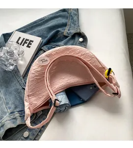 Interior view showing large capacity of the pink half-moon crescent bag with pleated fabric