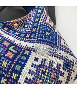 Detail of bohemian jacquard fabric on canvas bucket bag with bronze metal clasp
