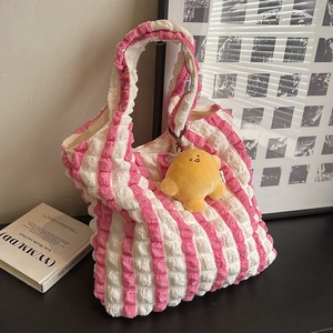 Pink and white striped bubble puff tote bag with a yellow croissant plush charm