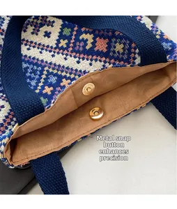 Detail of the golden hardware magnetic buckle on ethnic woven canvas bucket bag