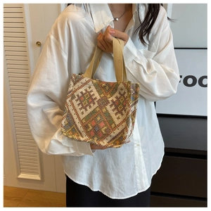 Ethnic geometric pattern canvas tote bag shown with casual white shirt and black skirt outfit