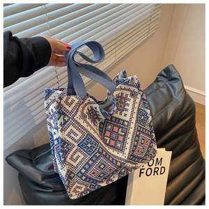 Detail of bohemian canvas tote bag with blue geometric pattern and thick woven handles