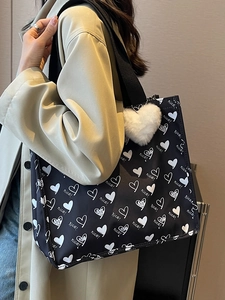 Black canvas tote bag with white hearts, 'nice!' text print and heart plush pendant