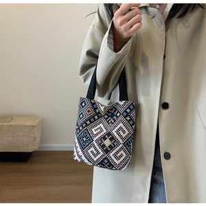 Close-up of ethnic geometric pattern woven canvas bucket bag with magnetic metal clasp