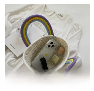 Detail view of woven straw basket bag interior holding cosmetics and a phone