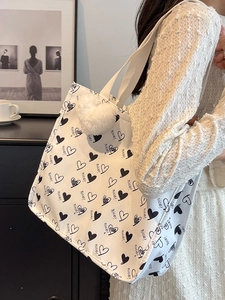 Large capacity canvas tote bag with heart patterns and plush ball pendant for women