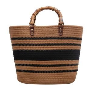 Handwoven straw tote bag with black stripes and natural bamboo handles for beach or travel