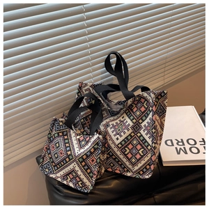 Close-up of ethnic geometric pattern canvas tote bags in two sizes with fabric texture