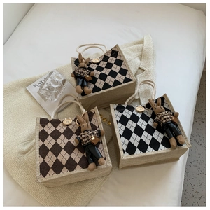 Close-up of linen tote bags with rhombic patterns, wooden buttons and cute rabbit charms