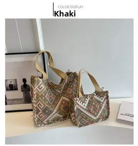Detail of khaki bohemian tote bag set with colorful geometric patterns on a white table