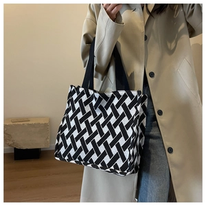 Close-up of black and white woven canvas tote bag with thick geometric texture detail