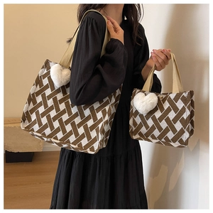 Detail of large knit tote and small handbag with geometric patterns and heart charm