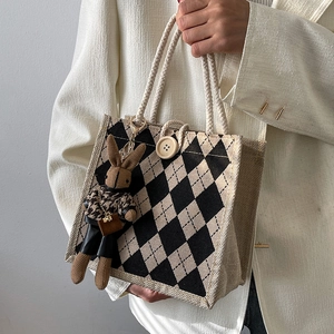 Linen tote bag with black and white checkerboard pattern and rabbit plush charm