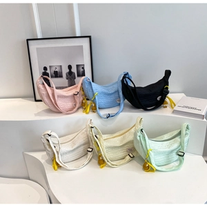 Detailed view of six crescent crossbody bags in various colors with cute duck charms