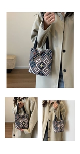 Detailed view of ethnic geometric woven pattern and black fabric handle on a mini tote bag