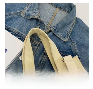 Detail of durable canvas tote handle with reinforced stitching and minimalist texture