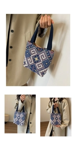 Close-up of geometric jacquard knit handbag with dark blue handles and magnetic closure