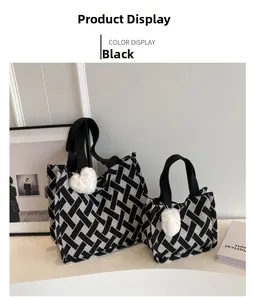 Detailed view of black and white geometric woven tote bags in two sizes with heart charms