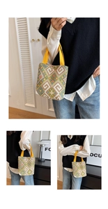 Detail of colorful geometric woven pattern on ethnic style bucket bag with yellow handles