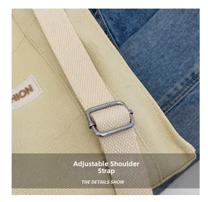 Detail of adjustable thick canvas strap with silver metal buckle and side logo label