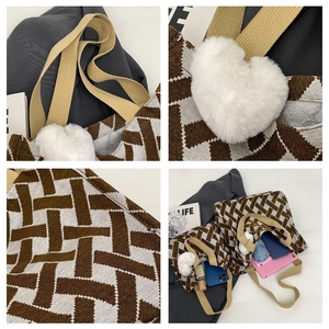 Detail view of woven tote bag showing heart charm and large storage capacity