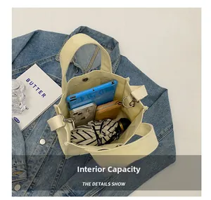 Internal capacity of canvas tote bag showing tablet and daily essentials storage
