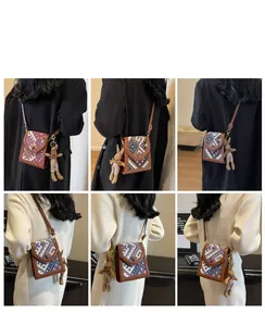 Detail of woven crossbody bag with geometric patterns and a cute plush bunny charm