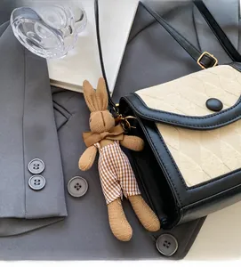 Détail du sac à rabat contrasté avec matelassage et charm lapin en peluche mignon