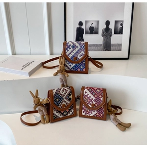 Detailed trio of ethnic style crossbody bags with woven patterns and rabbit charms
