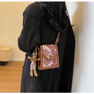 Ethnic crossbody bag with geometric pattern weaving and cute plush rabbit keychain