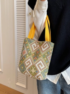 Ethnic knit bucket tote bag featuring vibrant retro geometric patterns and yellow straps