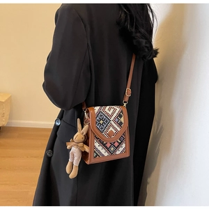 Bohemian crossbody phone bag with geometric woven flap and plush rabbit keychain charm