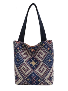 Ethnic geometric jacquard tote bag with navy blue straps and gold snap closure